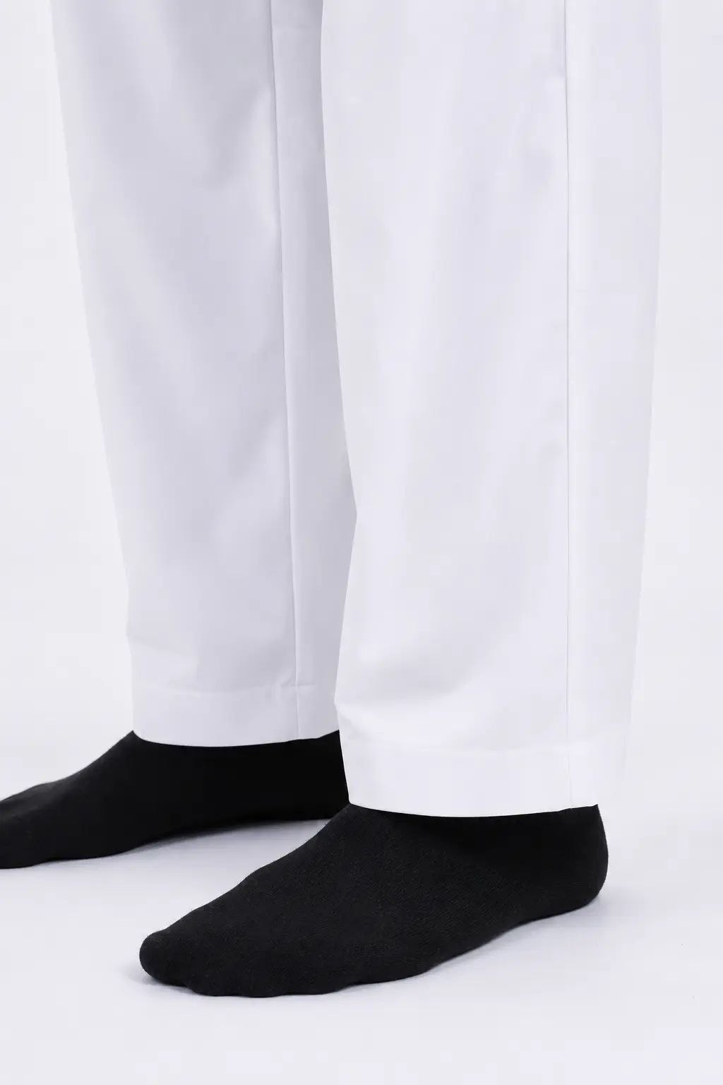 ChatGPT Image Jul 1, 2026, 02_53_34 PM (6) Lower legs wearing white pants with black socks on a white background.