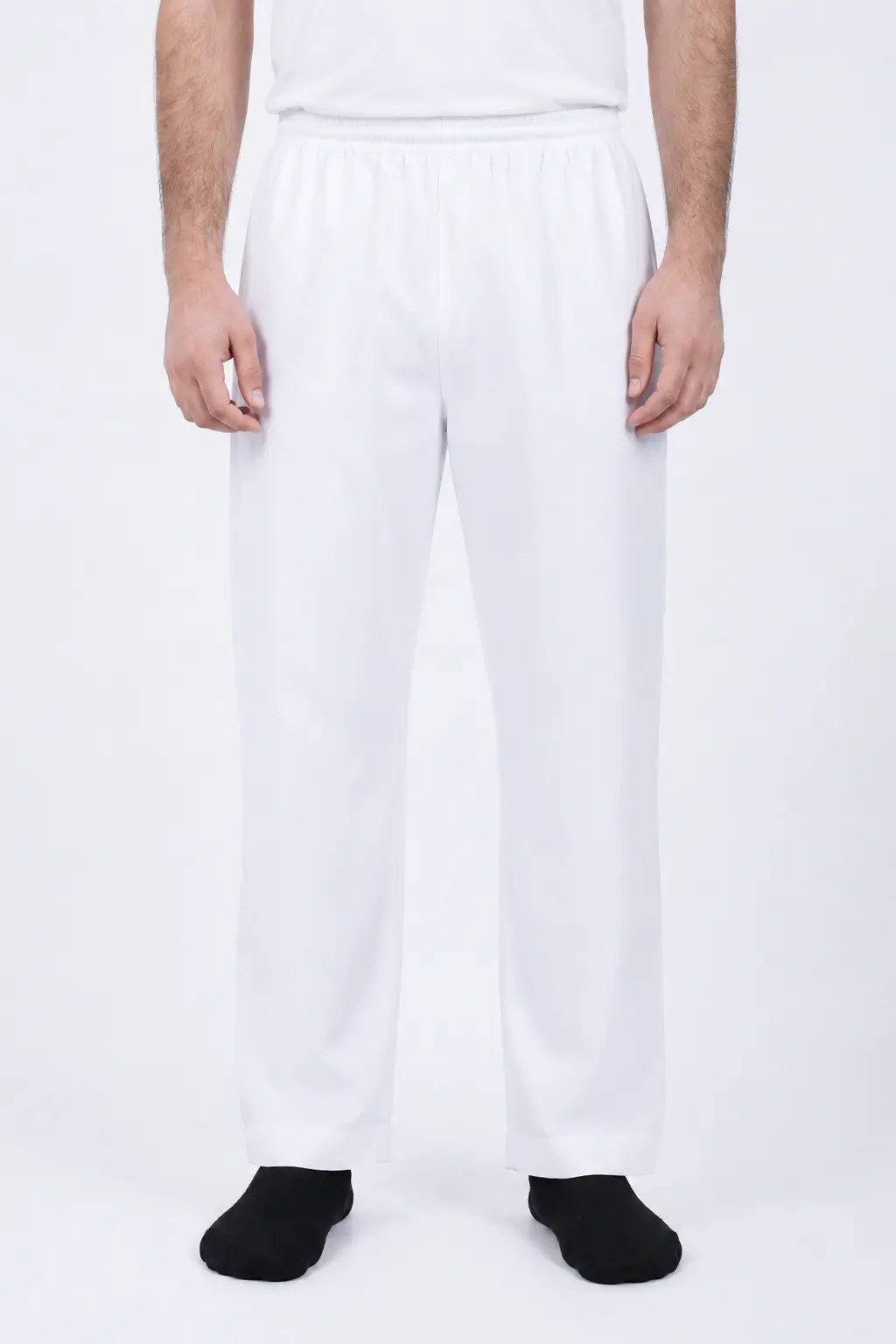 ChatGPT Image Jul 1, 2026, 02_53_31 PM (1) Person standing, wearing white elastic-waist pants and a white shirt, with black socks visible at the feet.