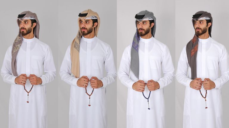 A collection of four premium Yemeni shemaghs by alqamees in earth-tone colors including taupe, beige, and slate grey, styled with white thobes, igals, and tasbihs to showcase unique machine-crafted patterns and soft-feel fabric.