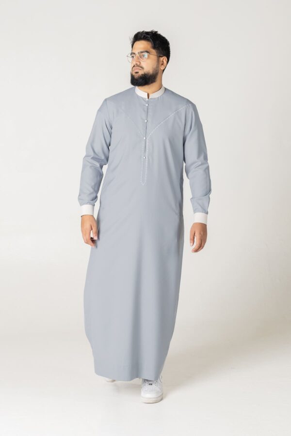 Steel grey and black contrast thobe by alqamees. Features a textured collar and embroidered placket for a modern, sophisticated style.