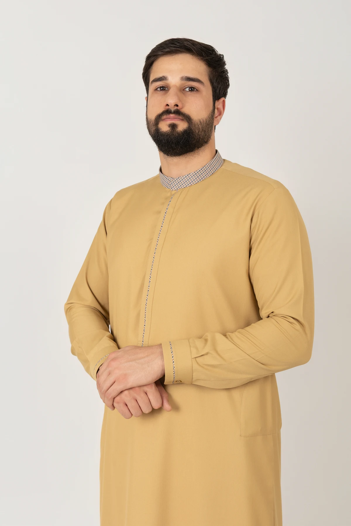 C-XC-160-Guard-1-alqamees-Mustard-thobe-1.webp Men’s mustard yellow thobe with textured collar by alqamees. A ready-to-wear thobe featuring a modern tailored fit, tonal embroidery, and premium fabric, representing the signature craftsmanship of the alqamees collection.