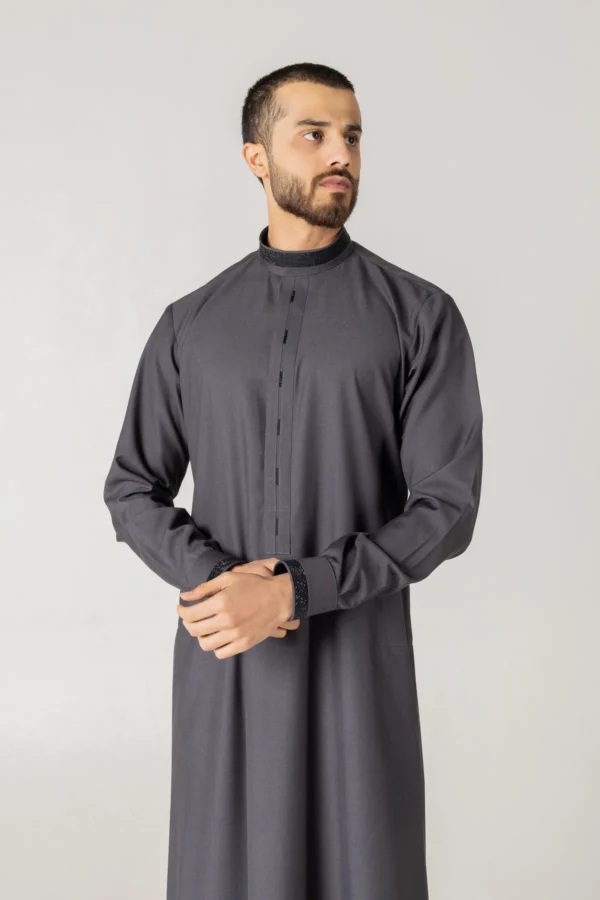 Classic charcoal grey thobe for men by alqamees. A sophisticated, ready-to-wear thobe featuring a modern tailored fit, mandarin collar, and premium fabric, perfect for formal or everyday modest wear.