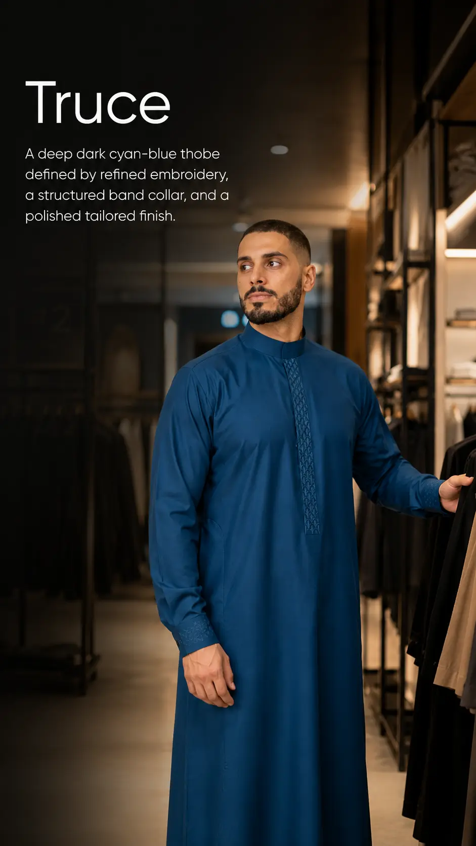In-store photo of a man wearing a deep cyan-blue thobe with a structured collar and decorative front panel, standing beside clothing racks; large text in the corner reads 'Truce' with a descriptive tagline about the garment.