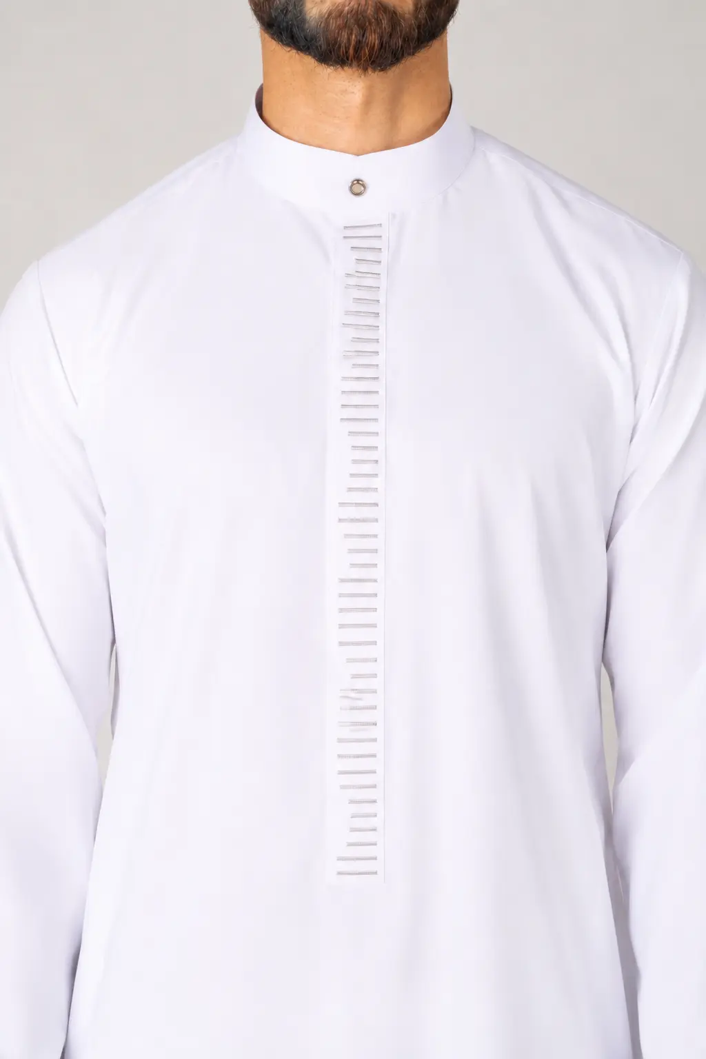 Rasasi White Edition (4) Man wearing a white kurta with a high mandarin collar and a vertical stitched placket down the chest.