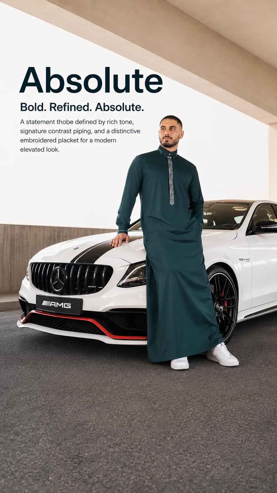 Man in a teal thobe leaning on a white Mercedes AMG in a showroom, with bold 'Absolute' advertising text on the wall behind him.
